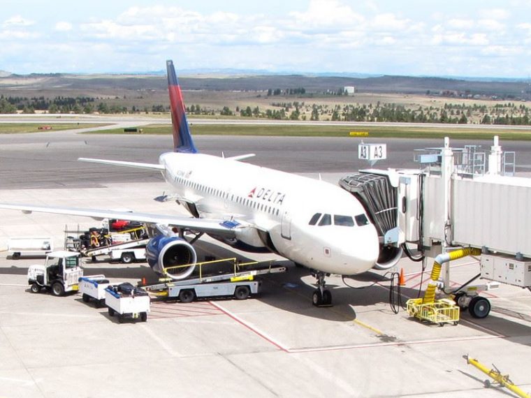 Billings Logan International Airport; Passenger Jet refueling and loading cargo and passengers at the terminal.