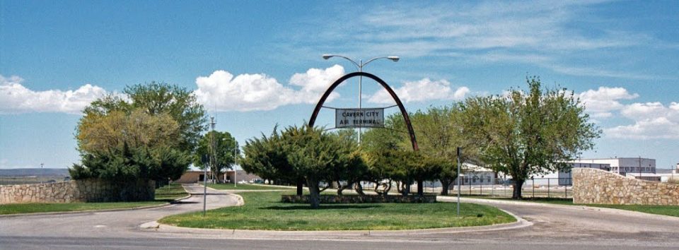Cavern City Air Terminal entrance with their sign and blue sky.