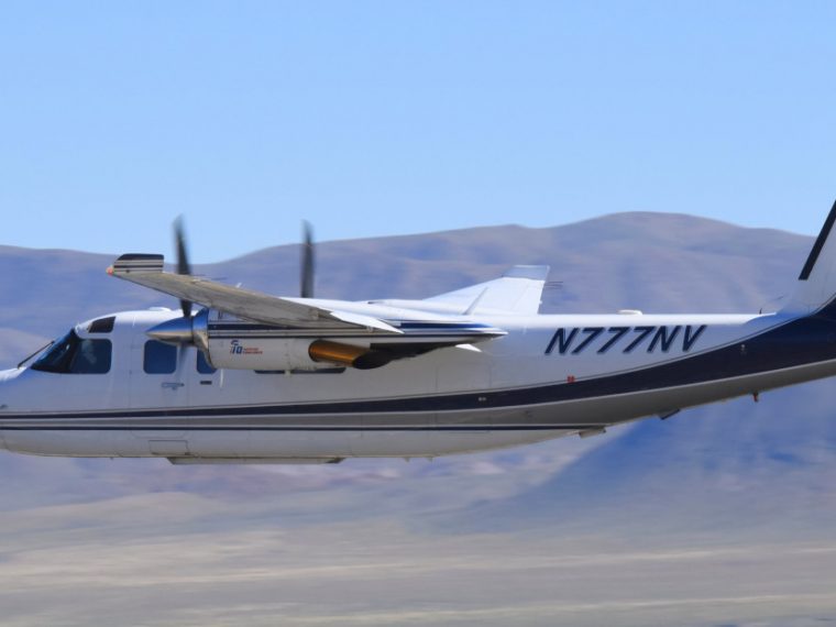 The Carson City Airport in Carson City Nevada, photo of a two prop plane in flight.